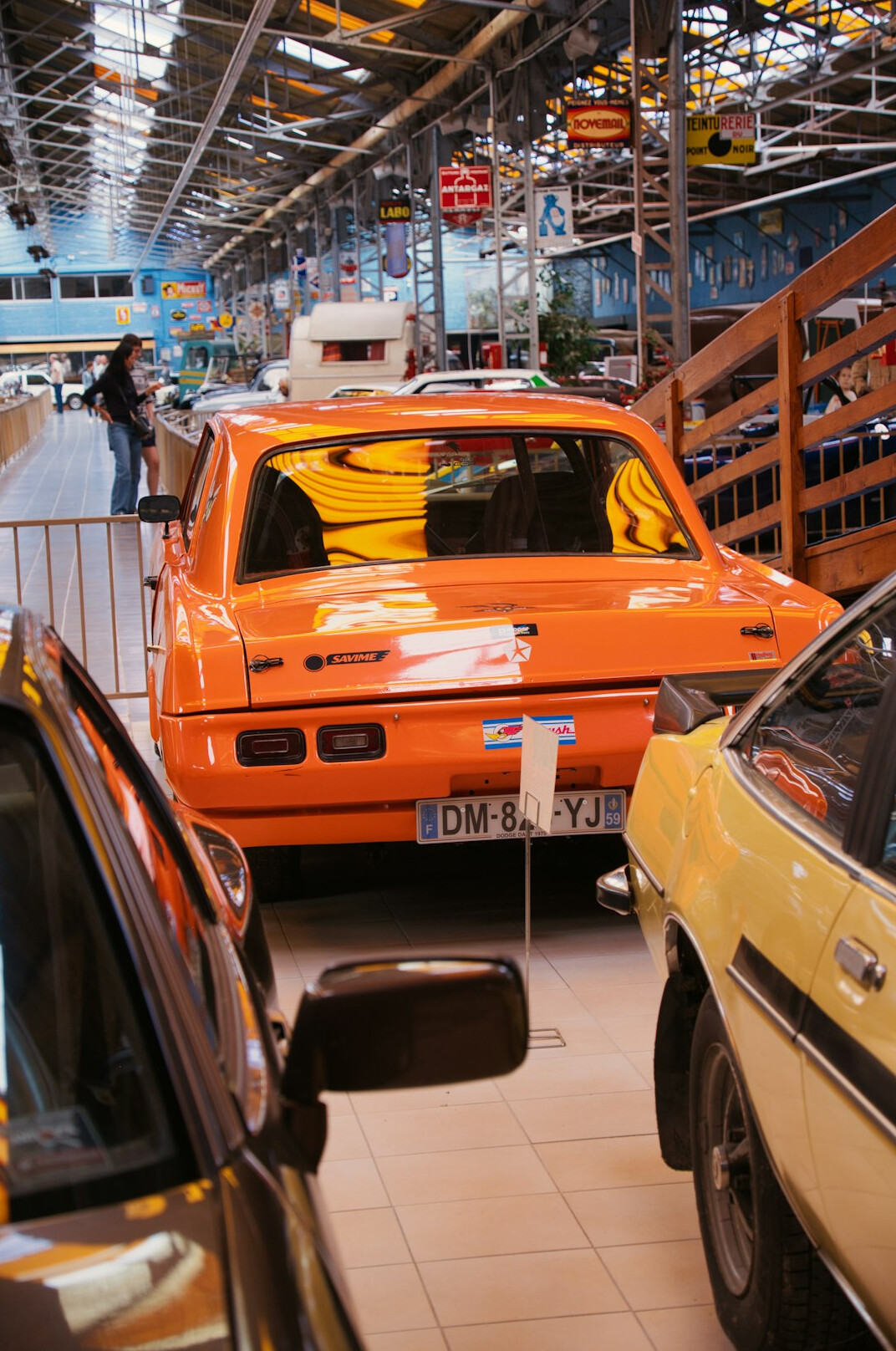 Interior of a classic car museum with rows of restored vintage automobiles