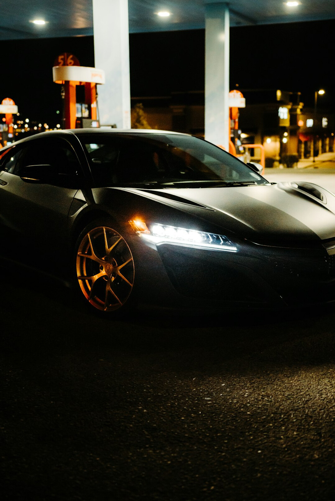 Modern hypercar with aggressive aerodynamic design photographed at night